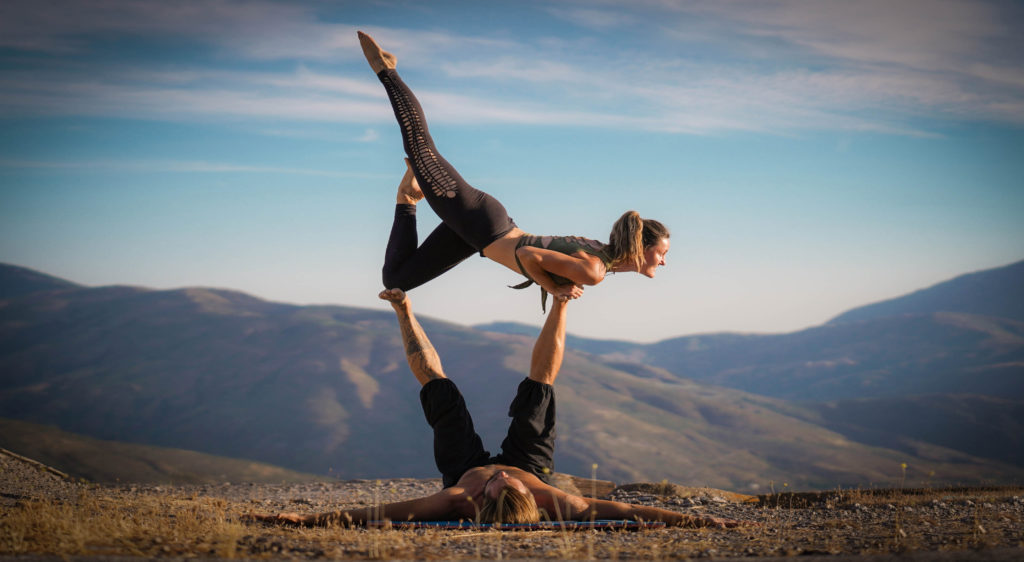 Beautiful AcroYoga pose with Lars basing in the mountains.